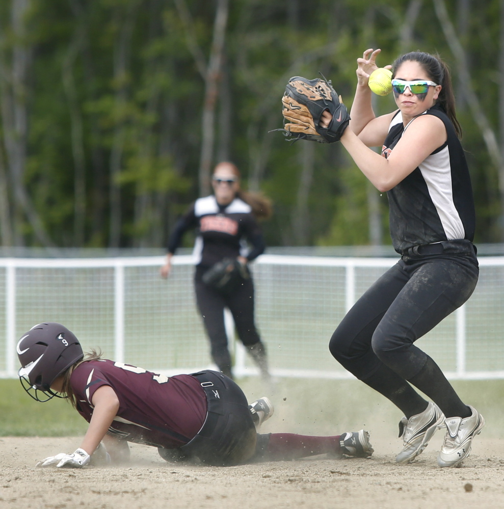 Biddeford shortstop Brittany Roy can’t maintain control of the ball while trying to turn a double play after forcing out Morgan Dube of Thornton Academy. Biddeford had its six-game winning streak broken.