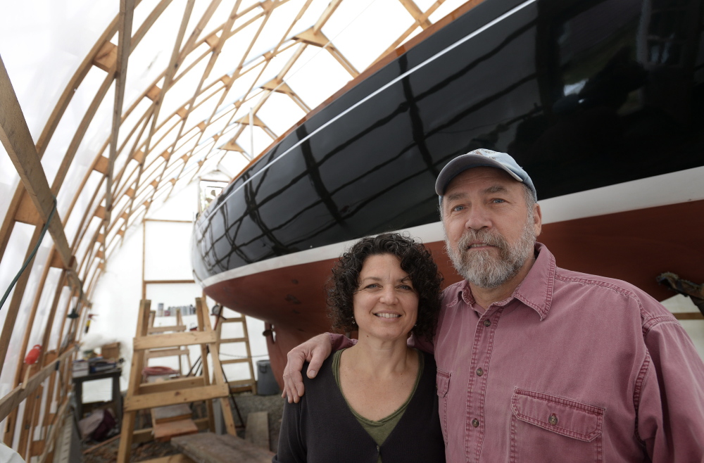 North Berwick artists Kim Bernard and Christos Calivas with Calivas’s 30-foot sailboat, which he will skipper up and down the Maine coast this summer