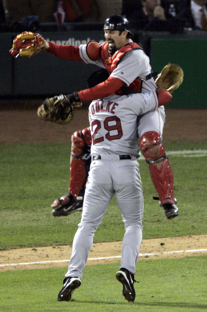 In what has become an iconic image of the first World Series victory for the Boston Red Sox in 86 years, pitcher Keith Foulke and catcher Jason Varitek celebrate the team's sweep over the St. Louis Cardinals on Oct. 27, 2004, in St. Louis.