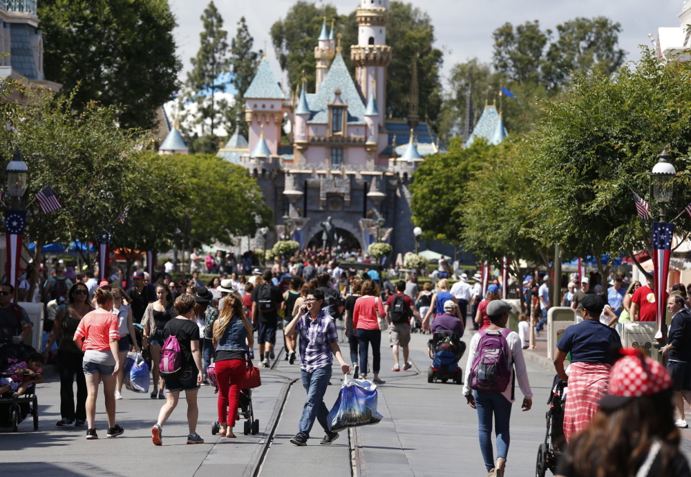 Patrons walk along Disneyland’s Main Street in Anaheim, Calif. Disneyland, which calls itself “The Happiest Place on Earth,” raised its entry prices a week before the Memorial Day weekend that marks the unofficial start of summer.