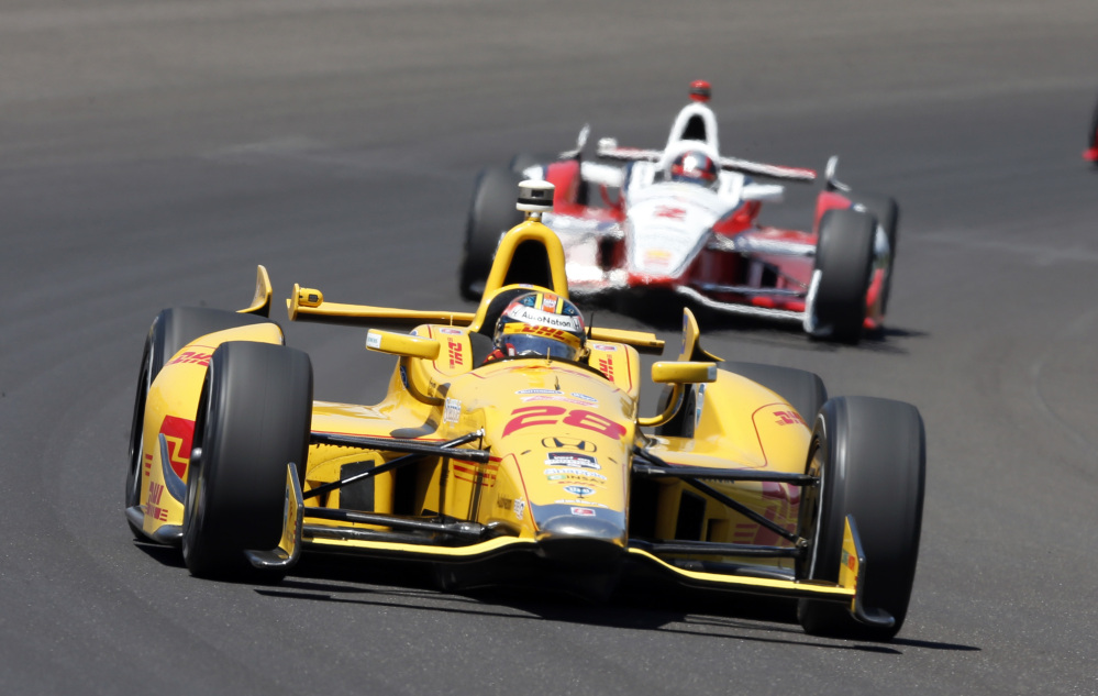 Ryan Hunter-Reay leads Juan Pablo Montoya, of Colombia, through the first turn during the 98th running of the Indianapolis 500 on Sunday.