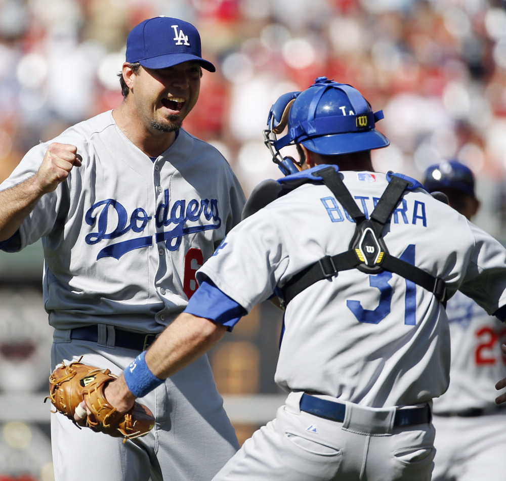 Dodgers pitcher Josh Beckett, left, celebrates with catcher Drew Butera after striking out Chase Utley of the Phillies to finish off a no-hitter Sunday in Philadelphia.