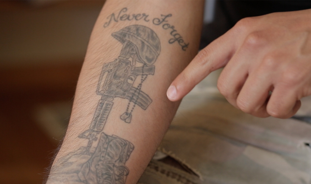 Brandon Deaton shows his tattoo, saying Memorial Day brings up difficult memories from his time serving in Iraq.