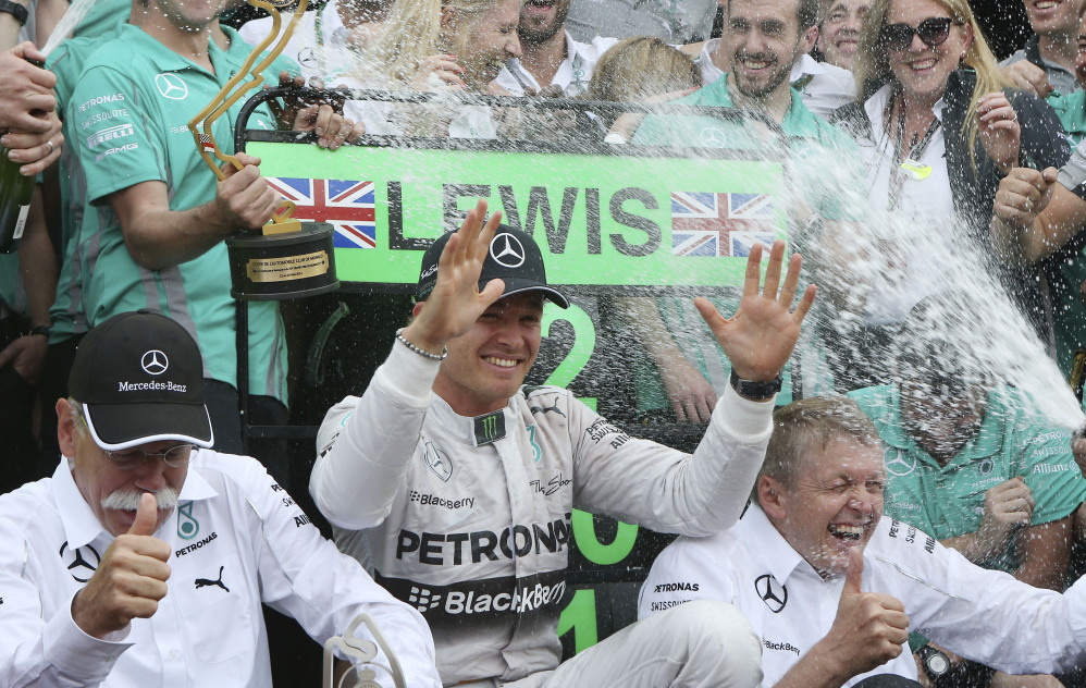 Mercedes driver Nico Rosberg, of Germany, celebrates with his team after winning the Monaco Formula One Grand Prix at the Monaco racetrack, in Monaco, Sunday.