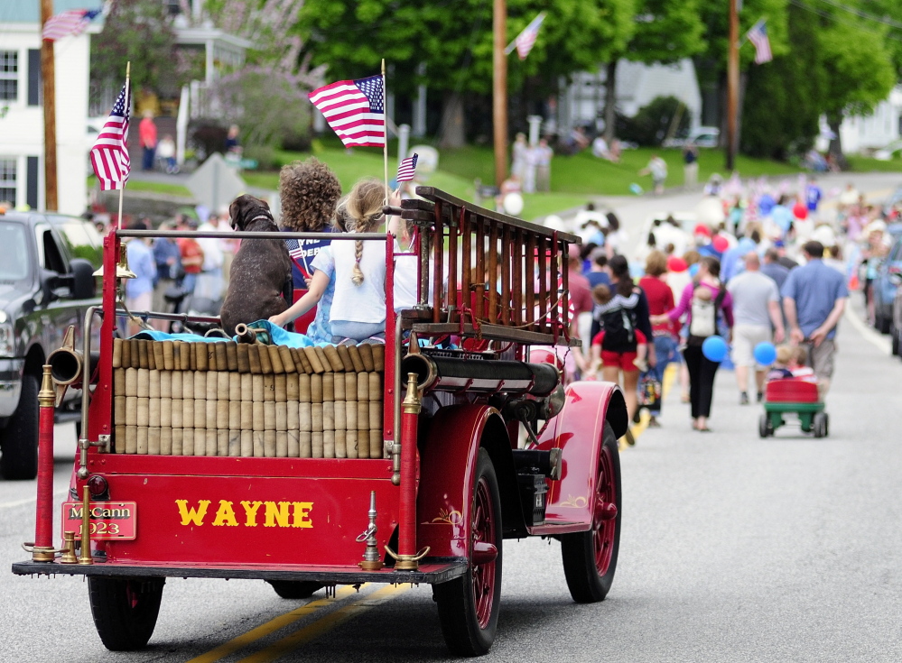 The Wayne Fire Department’s antique 1923 McCann fire truck drives down Main Street during the Memorial Day parade on Monday in Wayne.