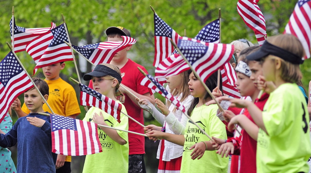 Wayne Elementary School students sing “You’re a Grand Old Flag” during Memorial Day events on Monday in Wayne. They learned the song from Bonnie Wilder of the Daughters of the American Revolution Koussinoc chapter.