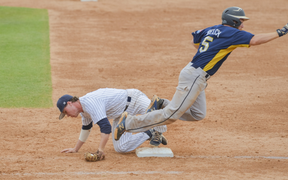 University of Southern Maine second baseman Paul McDonough goes to the ground to field a throw at first base during the sixth inning of a 15-3 loss to Emory University on Monday in the NCAA Division III championships in Appleton, Wis.