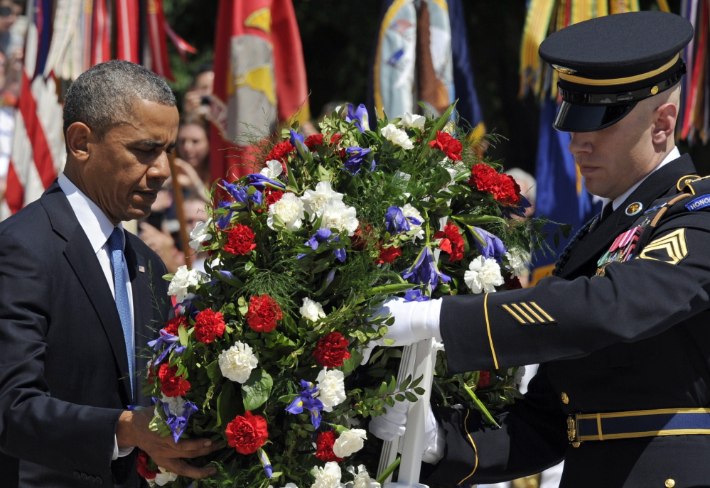 President Obama lays a wreath at the Tomb of the Unknowns at Arlington National Cemetery on Monday, leading the nation in remembering its war heroes.