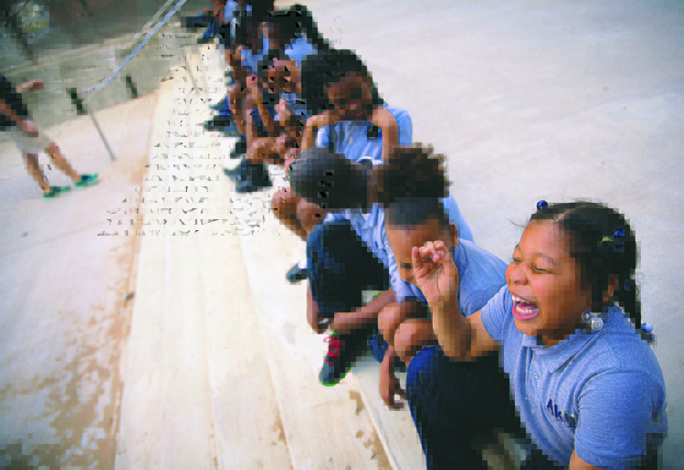 Ashiria Glasper, 6, and classmates take part in a physical education class at Akili Academy charter school, created by a $24 million restoration of an old New Orleans public school. Photo for The Washington Post by Edmund D. Fountain