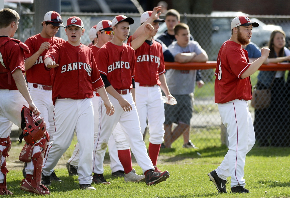 BIDDEFORD ME - MAY 20: Sanford's CJ Bulduc, right, is the first off the bench to cheer on teammates after getting out of an inning against Biddeford Tuesday, May 20, 2014. (Photo by Shawn Patrick Ouellette/Staff Photographer)