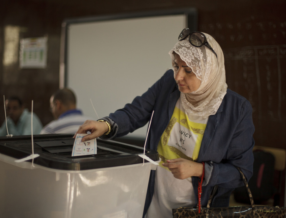 An Egyptian woman casts her vote Tuesday, the second and final day of the presidential election. Low turnout has marked both days of voting,