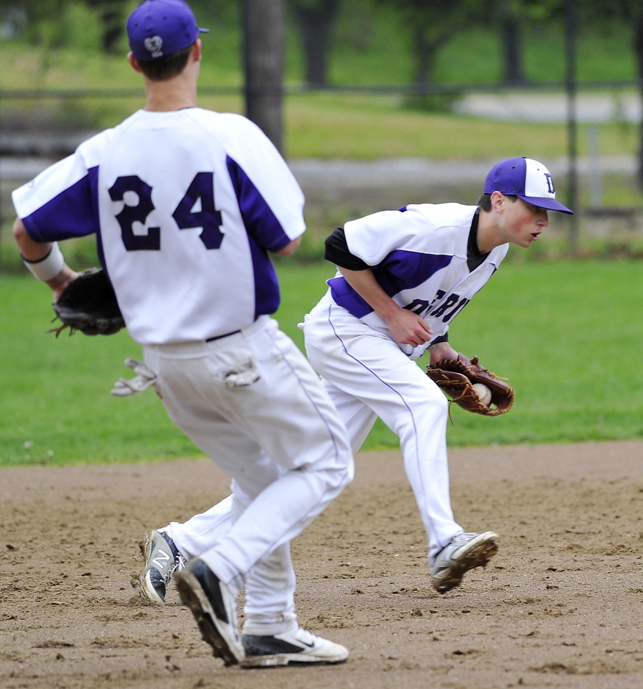 Deering shortstop Nick Bevilacqua fields a grounder before throwing the batter out as third baseman Will Barlock moves in Tuesday. The Rams fell to Portland 10-1 at Deering Oaks.