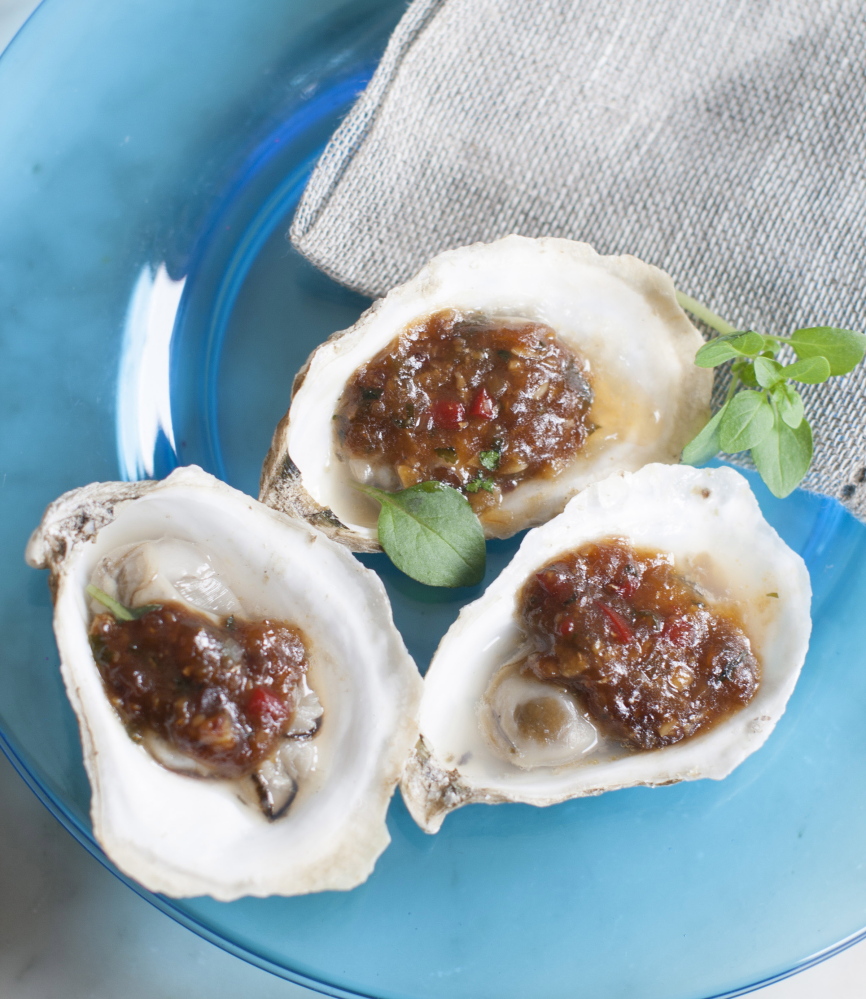 Grilled oysters with fermented black beans and chili garlic are inspired by chefs at the South Beach Wine and Food Festival in Miami Beach.