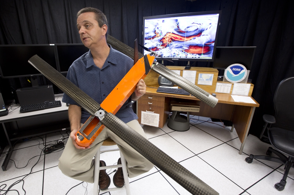 Joe Cione, who studies how storms interact with the ocean at the National Oceanic and Atmospheric Administrationís Hurricane Research Division in Miami, displays one of the drones he plans to test this hurricane season. The drones have a propeller and are controlled by someone in a hurricane hunter aircraft. They are designed to float on air currents, not fly against strong winds.