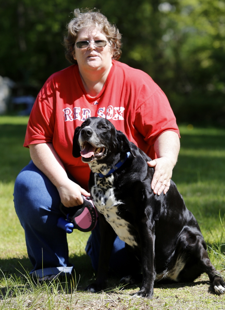 Derek Davis/Staff Photographer
Kathy Watts pets her therapy dog, Shadow, who she lives with at the Learning and Recovery Center in Brunswick. Sweetser, which operates the mental health center, announced that they may close the facility because the state will not increase funding.