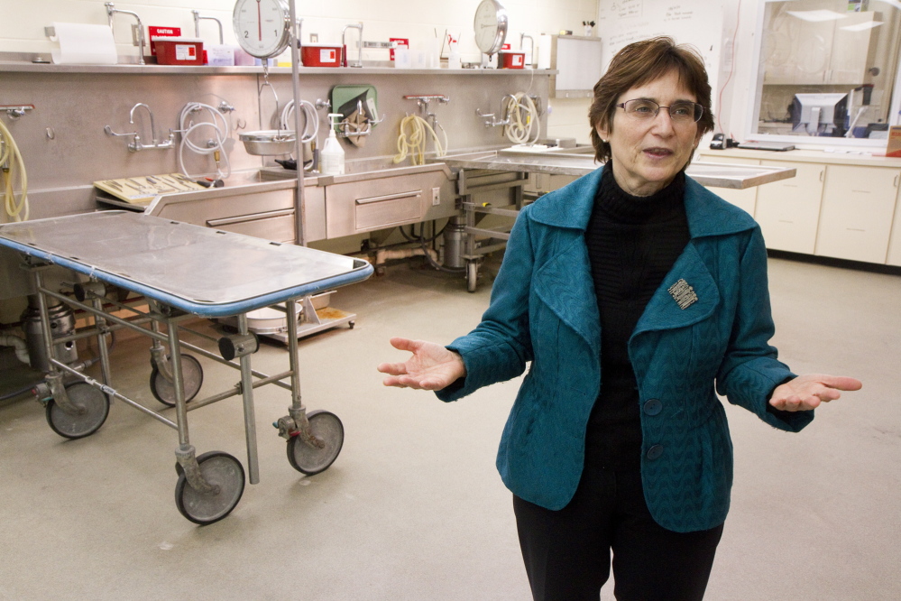 Dr. Margaret Greenwald talks about operations at the Office of Chief Medical Examiner inside the autopsy room in Augusta.
