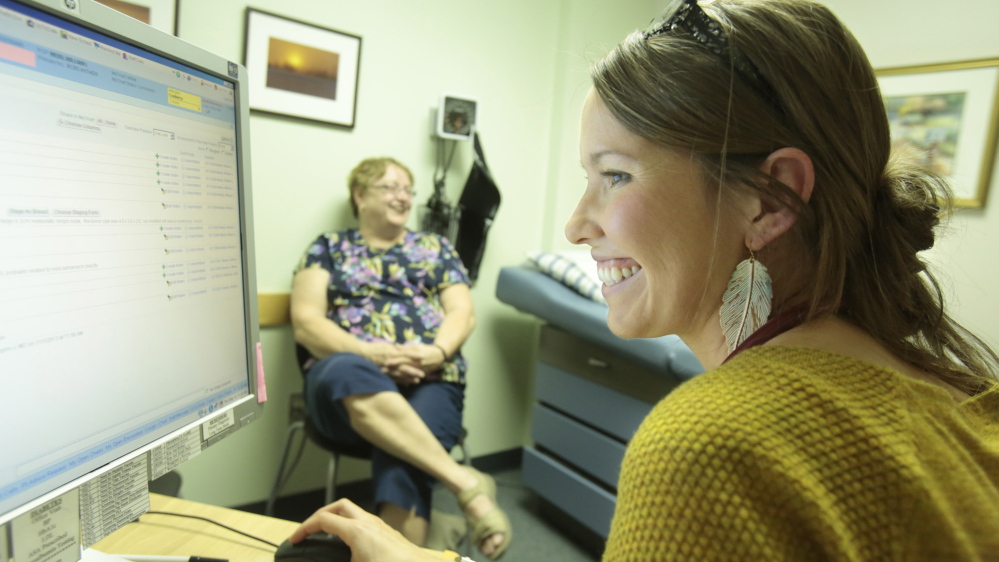 Rebecca Wood, right, visits the primary care practice of Dr. William Medd in Norway last month, while the doctor was seeing his patient Darlene Glover. Wood, who mentored with Medd, says she hopes to return to practice medicine in Maine after she completes her residency in New Hampshire.