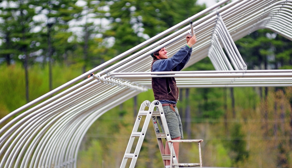 MONMOUTH, ME - MAY 14: Kevin Leavitt, assembles a high tunnel greenhouse on Wednesday May 14, 2014 on a Monmouth horse farm where he rents a field. Leavitt said that heâd use it to grow cucumbers and tomatoes for his CSA clients and customers at farmers markets. (Photo by Joe Phelan/Staff Photographer)