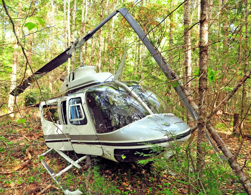 A helicopter sits in the wood after a crash landing on Friday in Whitefield.