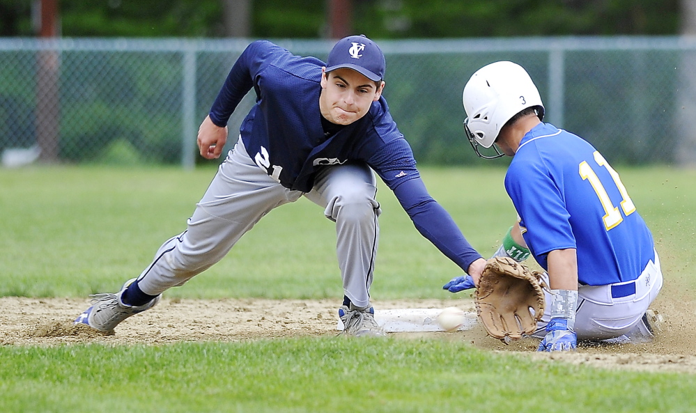 Luke Velas of Falmouth steals second base Friday as Cody Cook of Yarmouth attempts to catch the throw during Falmouthâs 5-4 comeback victory. Gordon Chibroski/Staff photographer