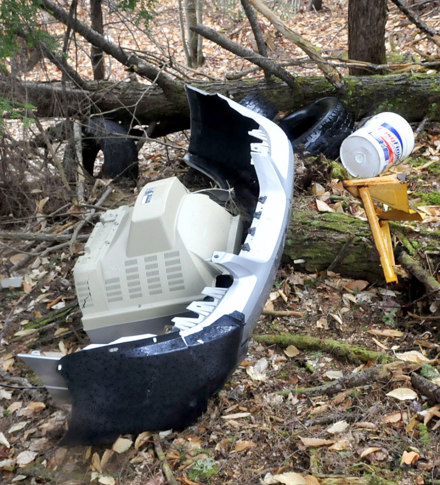 A television set, car bumper and other items lie where they were illegally dumped off Penney Road in Belgrade. David Leaming/Morning Sentinel