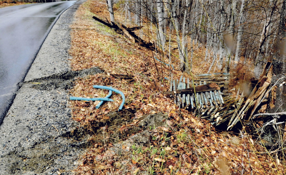 David Leaming/Morning Sentinel
Tire tracks remain in the shoulder of Penney Road in Belgrade after someone apparently backed up and dumped piles of debris there recently.