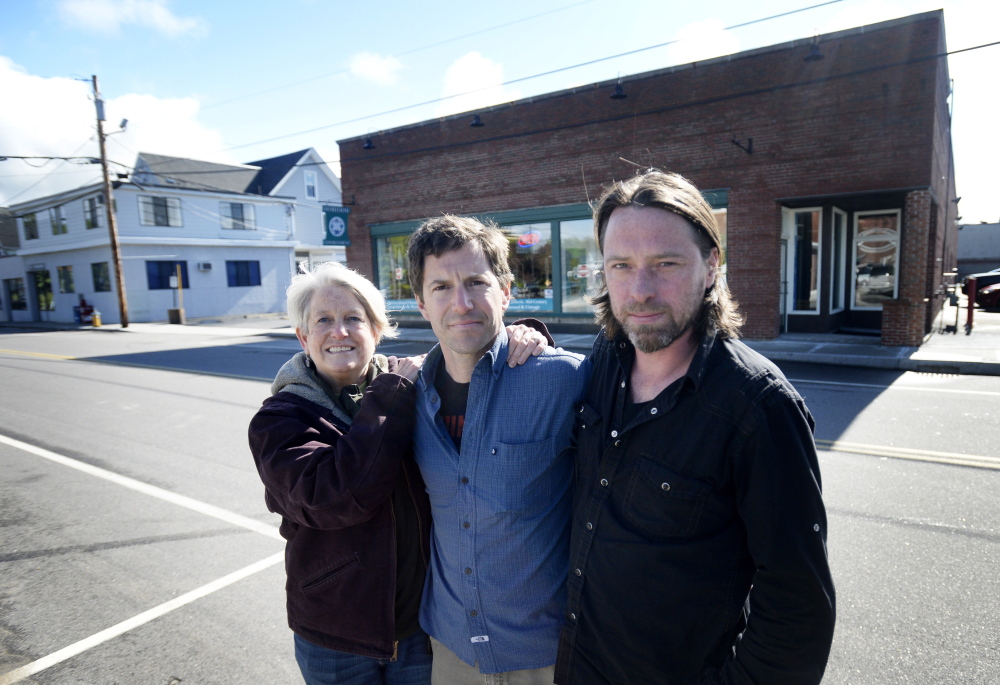 Penny Jordan, left, and Ben Slayton, center, pose with Joe Fournier, who will be the general manager of their new store in South Portland. They plan to sell locally grown and raised produce and meats in the building shown behind them, 161 Ocean St. Their mission is make local foods easily accessible to ordinary families. Shawn Patrick Ouellette/Staff Photographer