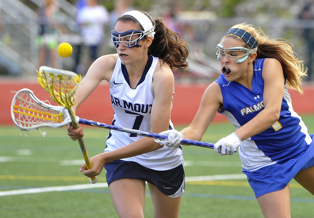 Ellie Fitzgerald of Falmouth, right, knocks the ball away from Lauren Bartlett of Yarmouth during Yarmouthâs 17-9 victory Wednesday in a schoolgirl lacrosse game at Yarmouth High. Photos by Gordon Chibroski/Staff Photographer