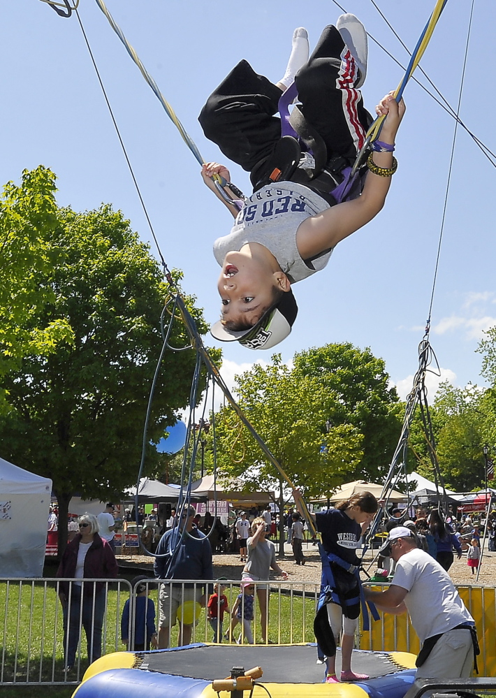 Ethan Gautreau, 8, of Westbrook, enjoys doing back flips on a trampoline at the Westbrook Together Days festival which celebrated the 200th anniversary of the city. Photos by Gordon Chibroski/Staff Photographer
