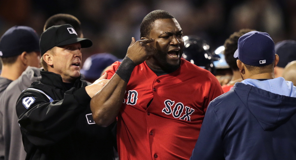 Boston Red Sox designated hitter David Ortiz is held back by umpire Jeff Kellogg after benches cleared after Tampa Bay Rays starting pitcher David Price hit Mike Carp with a pitch during the fourth inning of a baseball game at Fenway Park in Boston, Friday, May 30, 2014. The Associated Press/Charles Krupa
