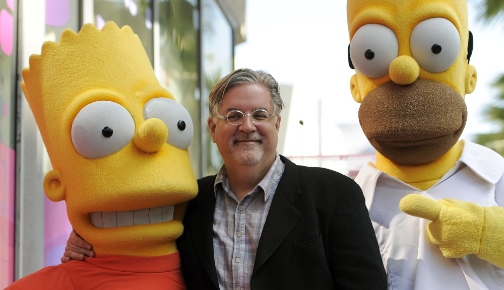 Matt Groening, creator of âThe Simpsons,â poses with his characters Bart Simpson, left, and Homer Simpson. The Associated Press