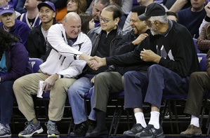 Steve Ballmer, left, shakes hands with former NBA players Bill Russell, right, and "Downtown" Freddie Brown as Omar Lee looks on during an NCAA college basketball game in January. Shelly Sterling has reached an agreement to sell the Los Angeles Clippers to Ballmer for $2 billion.