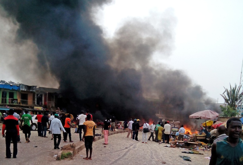 Smoke rises after a bomb blast at a bus terminal in Jos, Nigeria, Tuesday.