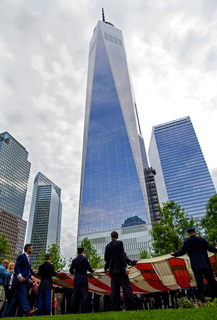 With One World Trade Center in the background, the National 9/11 Flag is unfurled during a ceremony at the 9/11 Memorial in New York on Wednesday. The ceremony marked the opening of the National September 11 Memorial Museum.