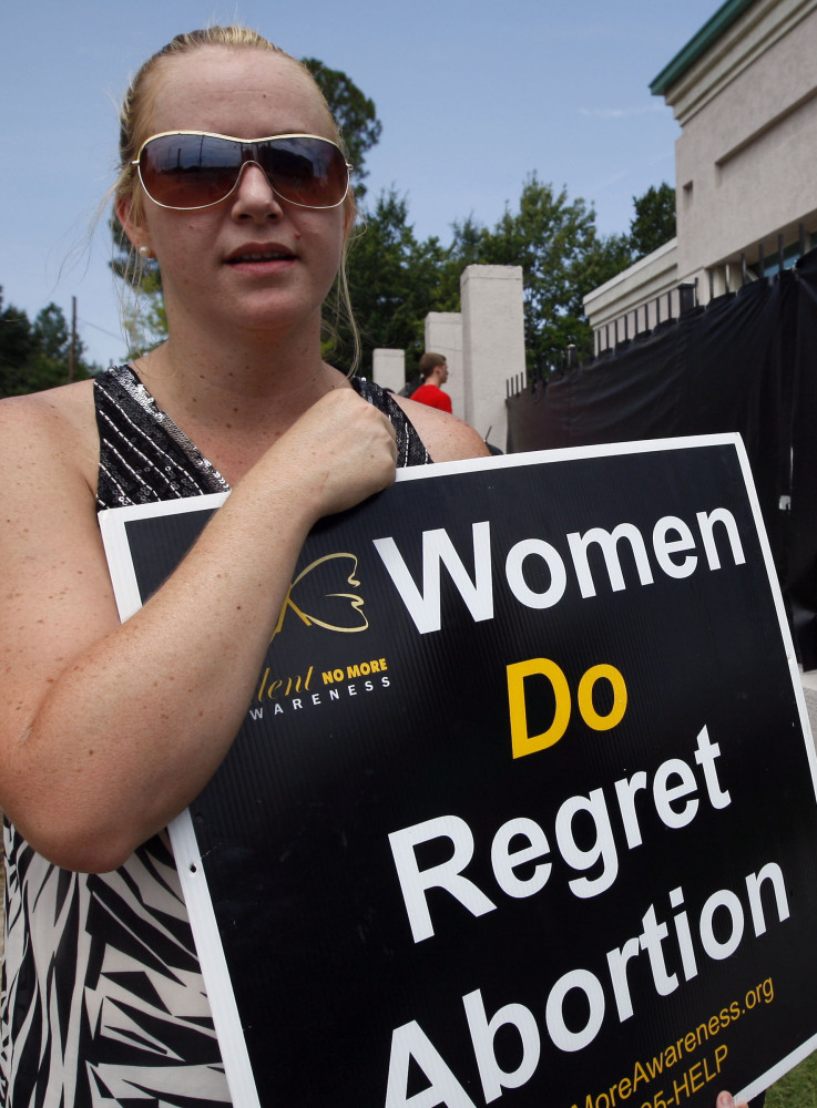 Ashley Sigrest of Brandon, Miss., protests abortion in 2012. New laws on hospital admitting may limit access to the procedure. The Associated Press