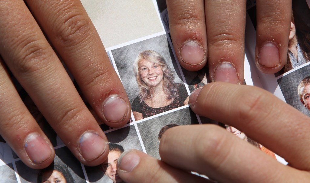 Wasatch High School sophomore Rachel Russell, 16, points to her altered school yearbook photo. Russell had sleeves added to her picture. 