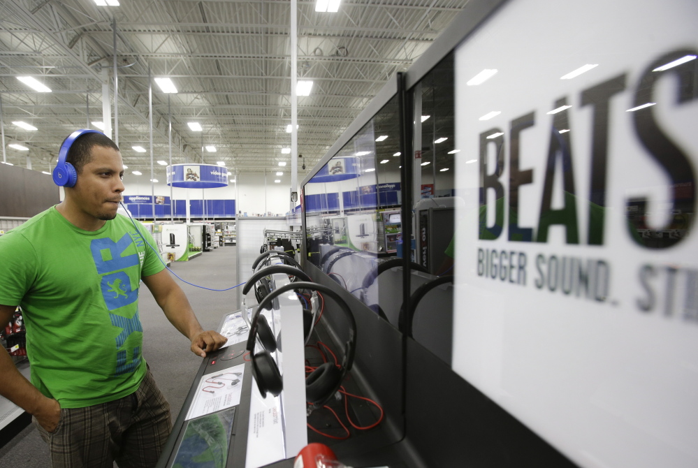 Eric Soriano listens tries a pair of Beats headphones at a Best Buy in Orlando, Fla. Appleâs lure to buy Beats, however, had more to do with the companyâs streaming music service as Apple looks to broaden its appeal in both music and hardware. The Associated Press