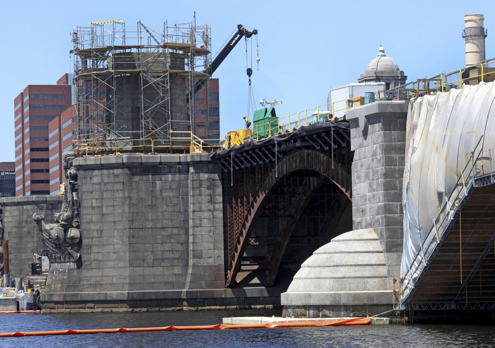 Contractors working to overhaul the Longfellow Bridge linking Boston to Cambridge, Mass., are getting an education in period engineering and scouring the region for appropriate materials. David L. Ryan/Boston Globe