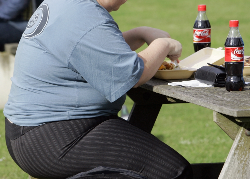 A heavy person eats a meal in London. About two in three adults in the U.K. are overweight, making it the fattest country in Western Europe. The Associated Press