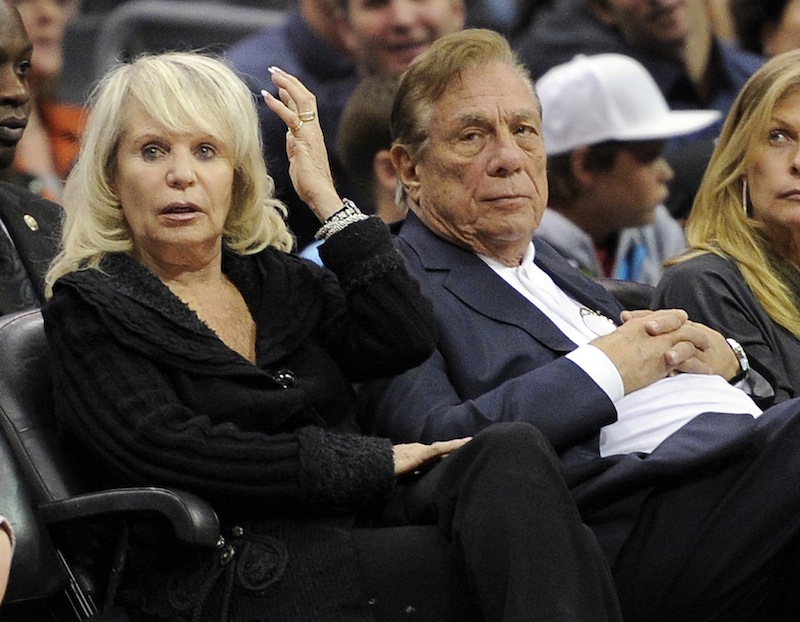 In this Nov. 12, 2010, file photo, Los Angeles Clippers owner Donald T. Sterling, right, sits with his wife Rochelle during the Clippers NBA basketball game against the Detroit Pistons in Los Angeles. An attorney representing the estranged wife of Clippers owner Donald Sterling said Thursday, May 8, 2014, that she will fight to retain her 50 percent ownership stake in the team.