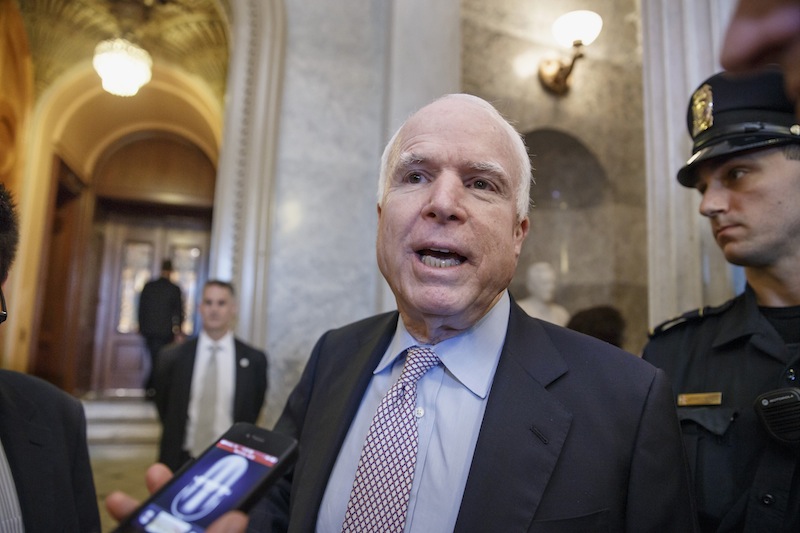 Sen. John McCain, R-Ariz. stops to speak with reporters as he heads to the Senate chamber for a vote on Wednesday.