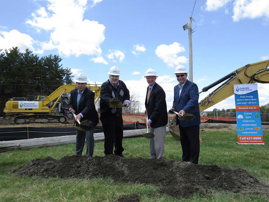 From left to right: Mike Minkos, president, Summit Natural Gas of Maine; Steve Woods, chairman, Yarmouth Town Council; Nathan Poore, town manager, Falmouth; and Bill Shane, town manager, Cumberland, all dig in the dirt at the groundbreaking ceremony at the Cumberland Fairgrounds.