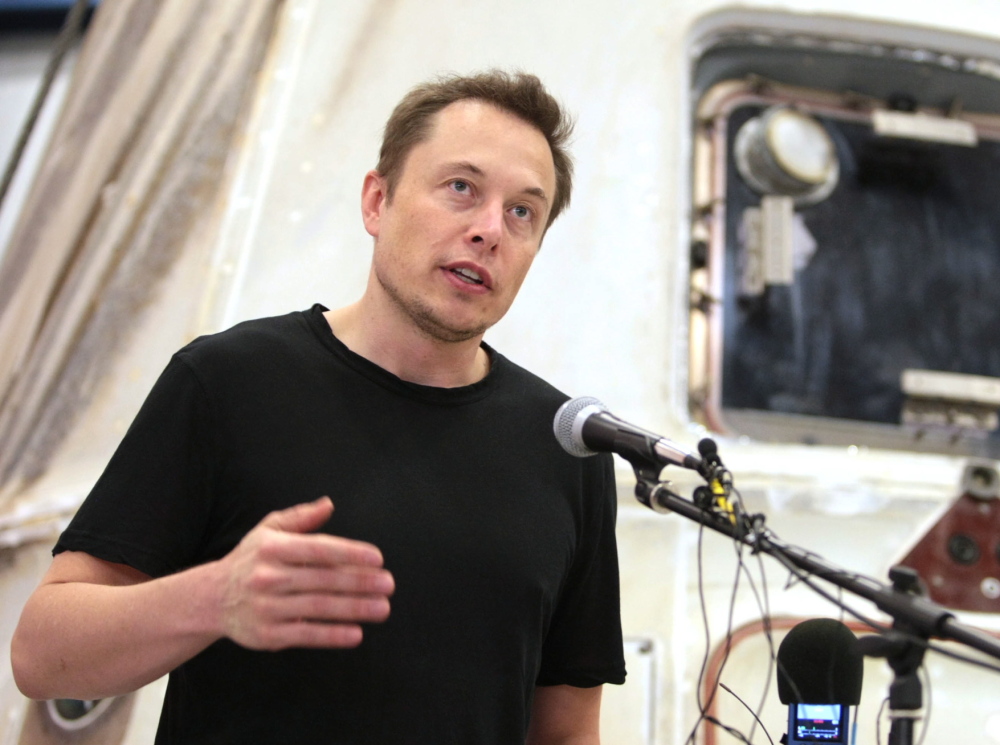 SpaceX CEO Elon Musk answers questions in front of the SpaceX Dragon spacecraft at the SpaceX Rocket Development Facility in McGregor, Texas, in 2012. The Associated Press