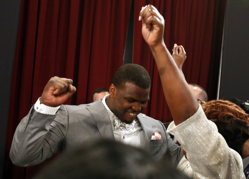 Greg Robinson, from Auburn, celebrates after being selected second overall in the first round of the NFL football draft by the St. Louis Rams on Thursday.