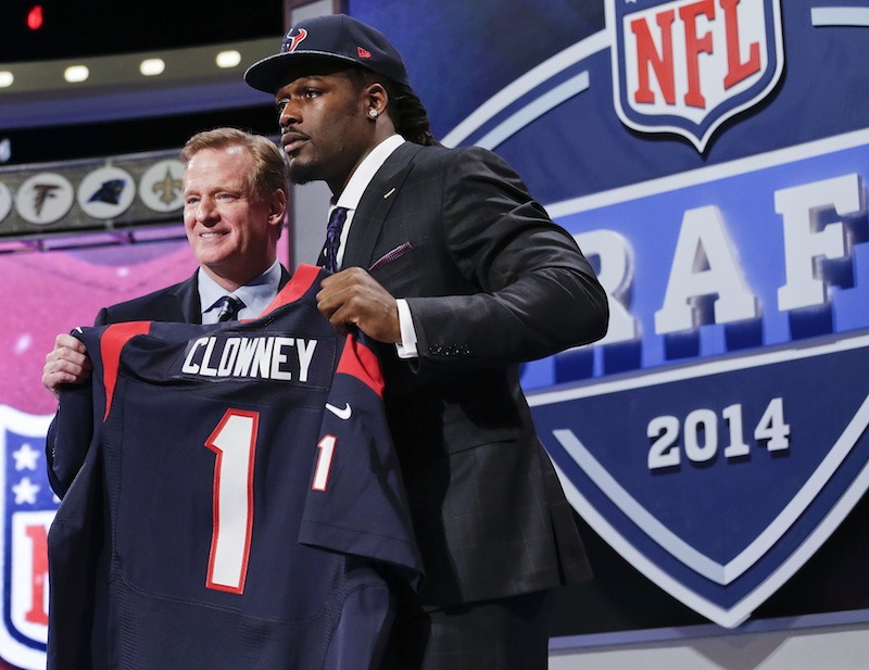 South Carolina defensive end Jadeveon Clowney holds up the jersey for the Houston Texans first pick of the first round of the 2014 NFL Draft with NFL commissioner Roger Goddell on Thursday in New York.