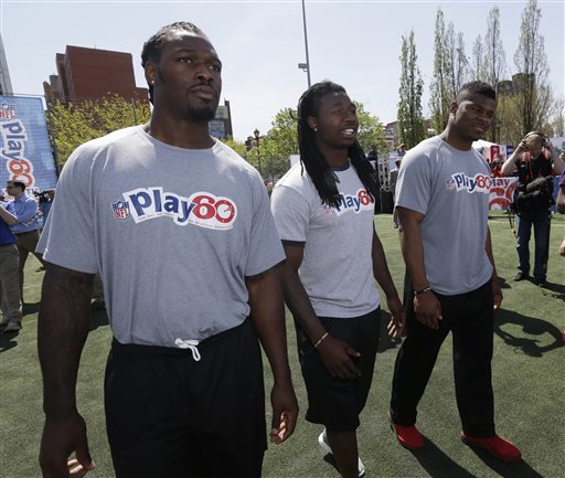 South Carolina's Jadeveon Clowney, left, Clemson's Sammy Watkins, center, and Buffalo's Khalil Mack participate in an NFL event in New York Wednesday. Clowney says of waiting for the NFL draft starting Thursday night: “I’ve been tired of it. I wish the draft was two or three weeks ago.”