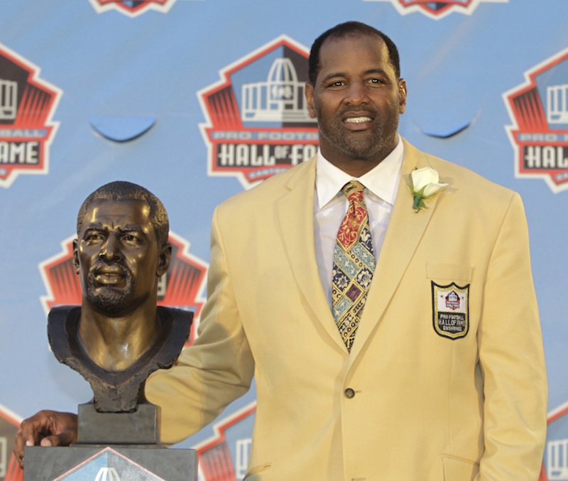 In this August 2011 file photo, Richard Dent poses with a bust of himself during induction ceremonies at the Pro Football Hall of Fame in Canton, Ohio. A group of retired NFL players says in a lawsuit that the league illegally supplied them with risky painkillers that numbed their injuries and led to medical complications.