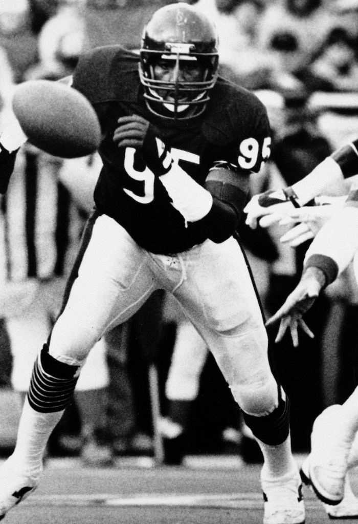 This January 1986 file photo shows Chicago Bears defensive end Richard Dent chases a loose ball during the NFL playoffs in Chicago. A group of retired NFL players says in a lawsuit filed Tuesday that the league, thirsty for profits, illegally supplied them with risky narcotics and other painkillers that numbed their injuries for games and led to medical complications down the road.