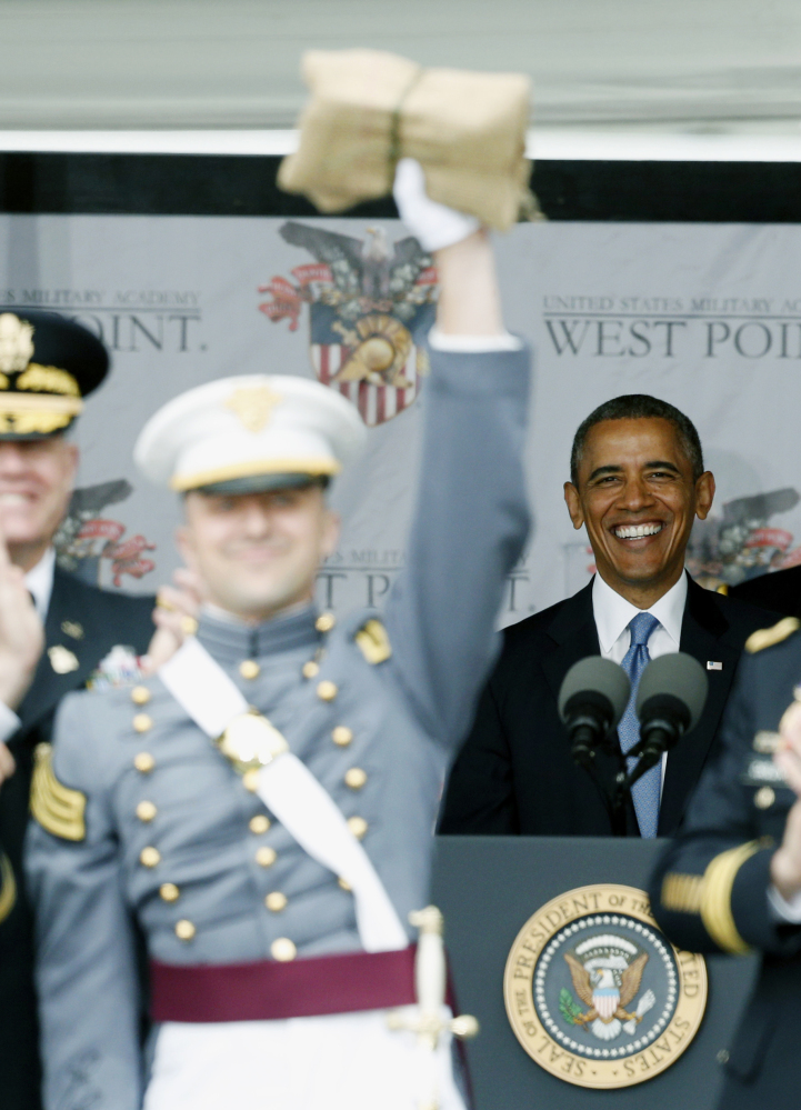 President Barack Obama smiles as Matthew Anthony Mayeaux of Long Beach, Miss., celebrates after graduating from the U.S. Military Academy during a ceremony Wednesday in West Point, N.Y. Mayeaux was the goat, which is the graduating cadet with the lowest grade-point average. The Associated Press