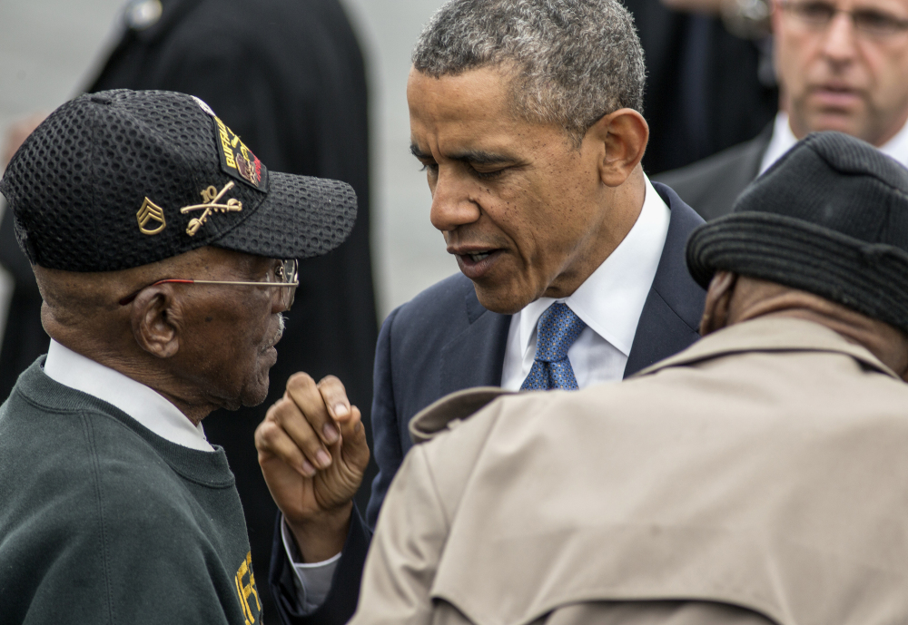 President Obama talks with World War II veterans Sanders Matthews Sr., born in 1921, left, and Lewis Coffield, born in 1918, both Buffalo Soldiers, after delivering the commencement address Wednesday at West Point. The Associated Press